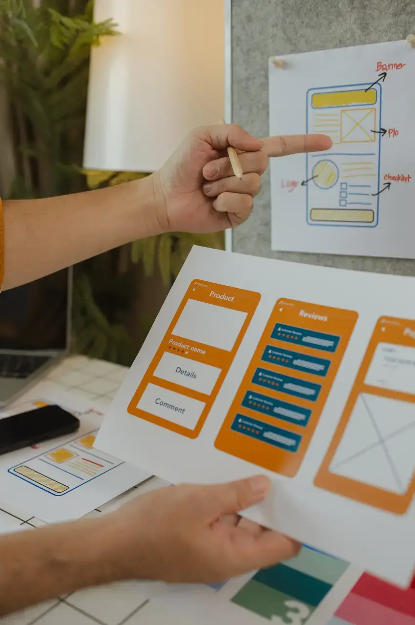 Designer reviewing an interactive UI/UX prototype with product page mockups